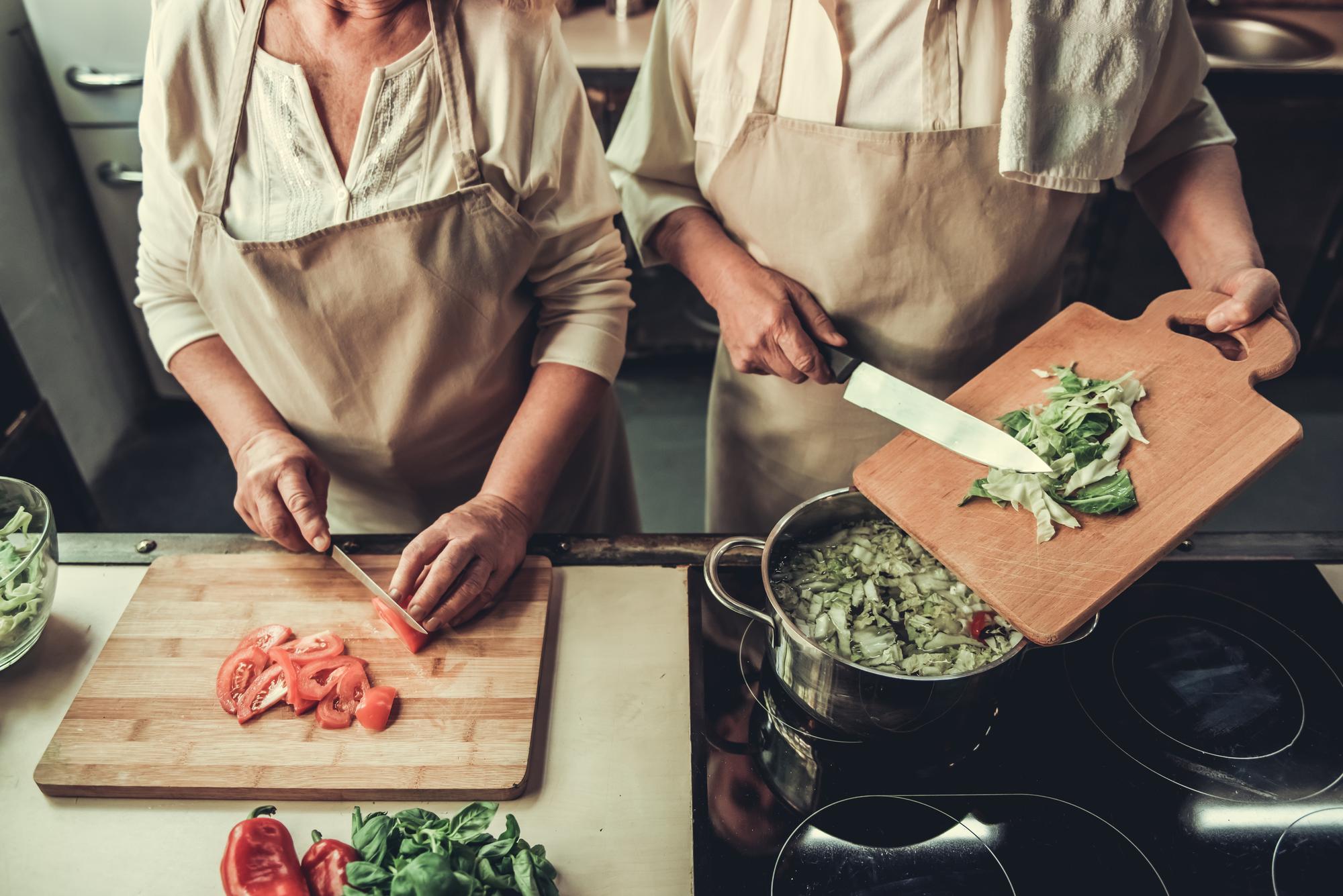 Small team in certified kitchen prepping meals